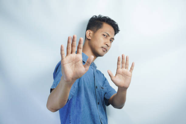 istock Attractive young asian man on isolated white background scared and terrified with frightened expression stop gesturing with hands, screaming in shock. Panic concept. 2148575862