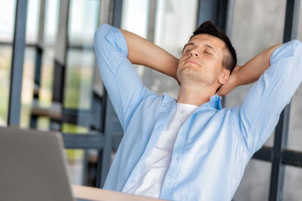istock Caucasian man relaxes in home office dreaming away 2148576722