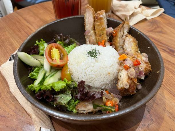 istock Chicken katsu with rice, vegetable salad and fresh sambal 2148578211