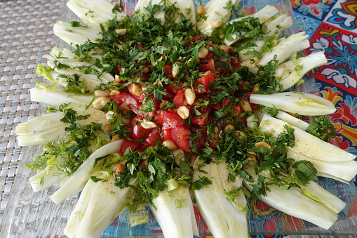 Portioned fennel pine nuts tomato beetroot chopped parsley on a serving platter  Appetizer buffet