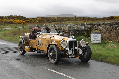 Caldbeck, England - April 13:  A 1936 Alvis Speed 25 Special leaves Caldbeck, Cumbria on April 13, 2024.  The car is taking part in the Flying Scotsman Rally, a free public-event.