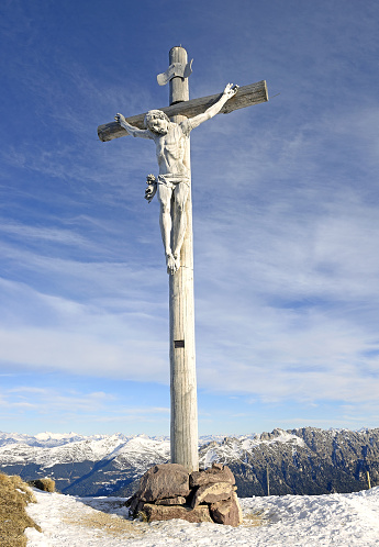 Dolomites, South Tyrol, Italy - Wooden cross on a mountain ridge to Mount Fermeda in Val Gardena, Puez. The Dolomites are UNESCO World Heritage Site.