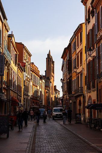 Rue du Taur, in the center of Toulouse, dominated by the imposing bell-gable in red bricks of the Church of Notre-Dame-du-Taur