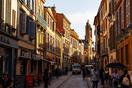 Rue du Taur, in the center of Toulouse, dominated by the imposing bell-gable in red bricks of the Church of Notre-Dame-du-Taur