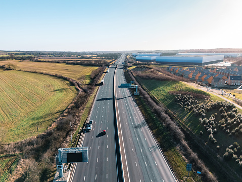 An aerial view of a straight section of the M1 motorway through the English Midlands