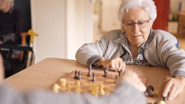 istock Senior friends playing chess in a nursing home 2148583243