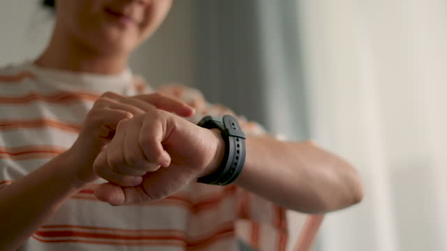 Close-up shot of woman touching on smartwatch, using smart watch application for checking time or taking pulse.