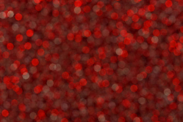 Abstract red blured glitter lights background. Circle blurred bright bokeh texture. Romantic backdrop for Christmas, new year, xmas, Valentines day, womens day, holiday or event