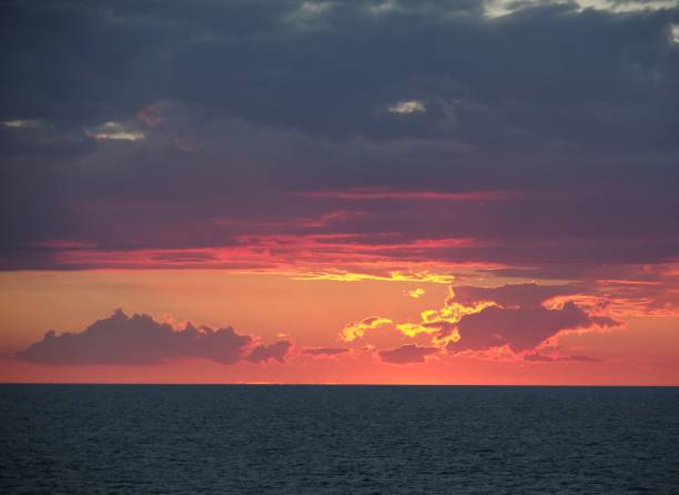 istock Sunset pink clouds ocean horizon background banner with copy space 2148583743