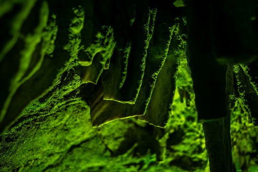 Journey through a vibrant cave adorned with colorful walls, stalactites, and stalagmites, revealing the underground beauty of nature's geological wonders.