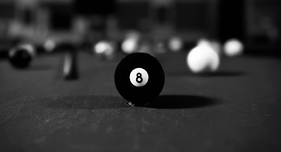 8 ball in the center of a pool table.