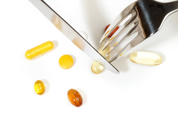 A visually focused image of various tablets and capsules disrupted across a polished wooden surface, showcasing pharmaceutical and health-related concepts in a vivid display. The composition emphasizes healthcare, medical supplies, and treatment in a clear and relatable manner.
