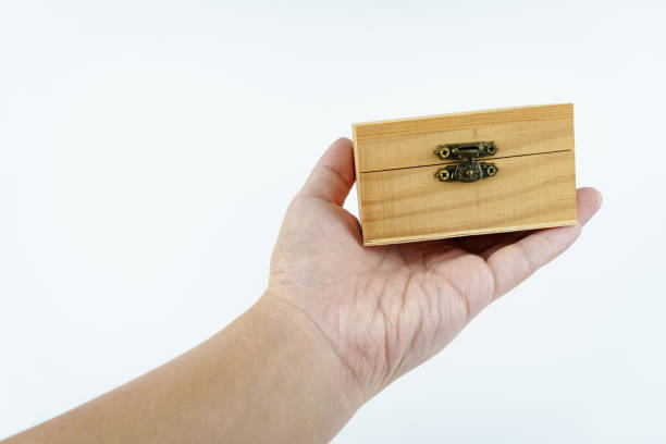 Vintage photographs and letters inside an old wooden box, surrounded by vintage post mail. High-view-angle image of photographs and letters from the beginning of the 20th century.