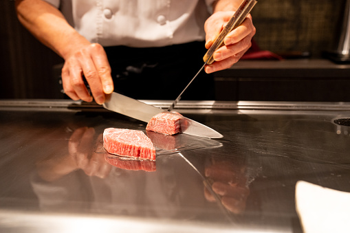 Close up of a chef slicing Kobe beef on hotplate