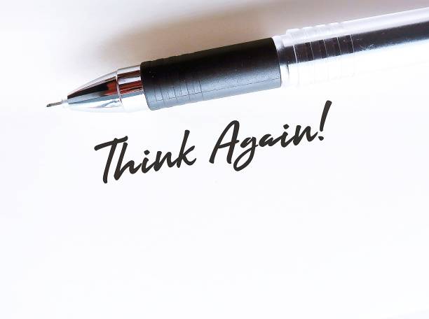 Pen writing on white paper THINK AGAIN , means to think twice or rethink before making decision,   rethinking can lead to excellence at work and wisdom in life