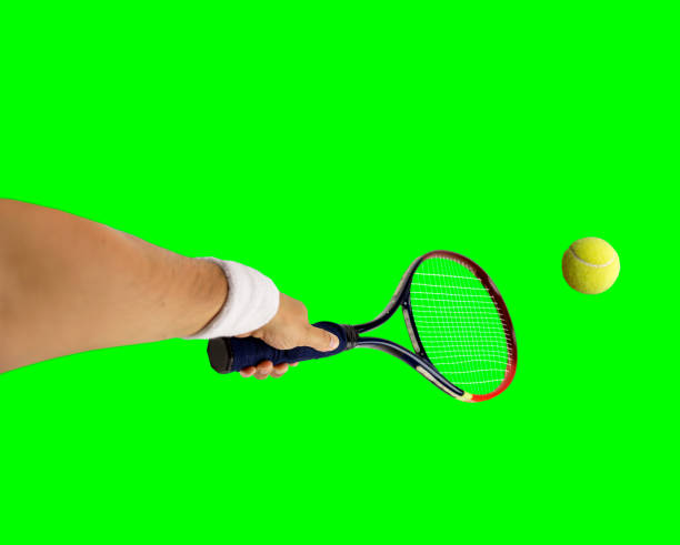 Tennis racket and tennis ball on a hardcourt.