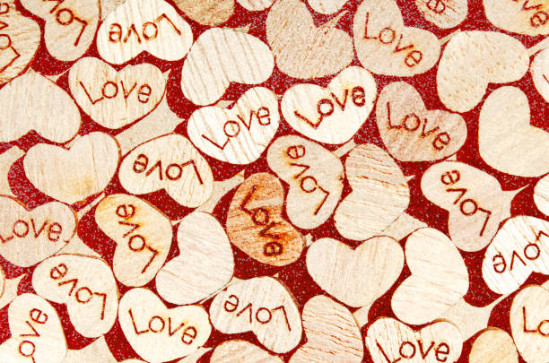 Heart shapes with love text on a craft paper background Wooden heart Love concept Monochrome template 14 february Pink defocused light