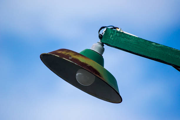 Close up image of a Street lamp hanging on a wooden pole
