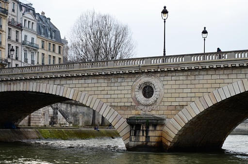 Paris, France 03.25.2017: Stone bridges over the river Seine in Paris