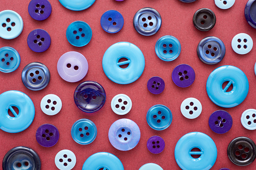 Close up of a huge group of blue-toned buttons on a table
