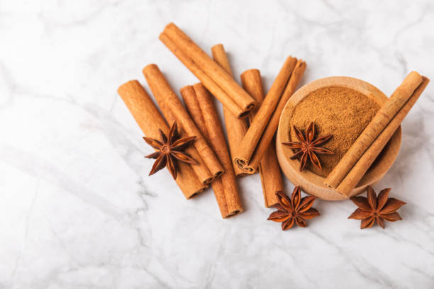 istock Cinnamon sticks and anise on a textured background. Cinnamon roll and star anise. Spicy spice for baking, desserts and drinks. Fragrant ground cinnamon.Place for text. copy space. 2148596363