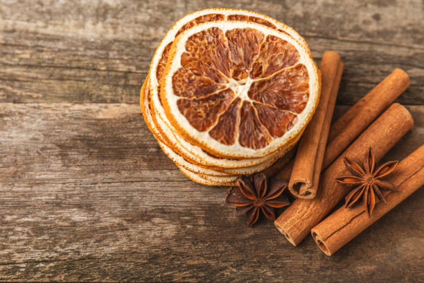 Cinnamon sticks and anise on a textured background. Cinnamon roll and star anise. Spicy spice for baking, desserts and drinks. Fragrant ground cinnamon.Place for text. copy space.