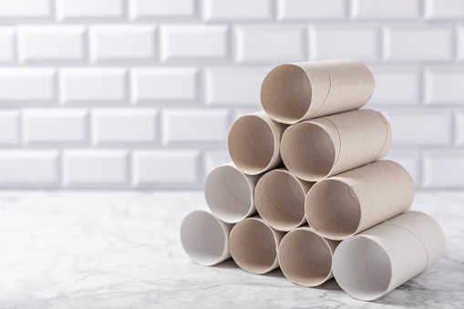 Empty toilet paper roll. Empty toilet paper rolls on  background. Paper tube of toilet paper. Place for text. Copy space. Flat lay. Eco-friendly reuse recycle