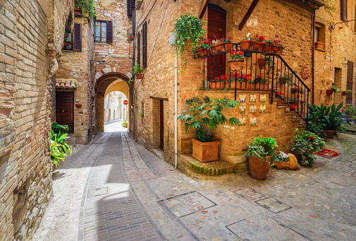 Narrow pedestrian streets and courtyards of Spello. Beautiful old street floral decoration medieval town Spello, Umbria, Italy. Summer, bright and cozy. A trip through the small towns of Italy