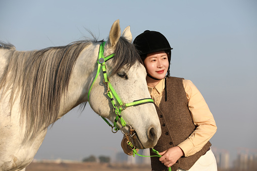 An Asian woman with a horse