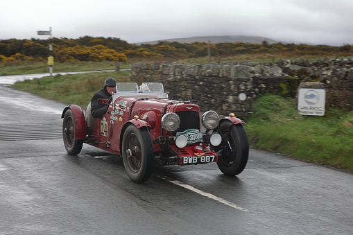 Caldbeck, England - April 13:  A 1934 Aston Martin Ulster leaves Caldbeck, Cumbria on April 13, 2024.  The car is taking part in the Flying Scotsman Rally, a free public-event.
