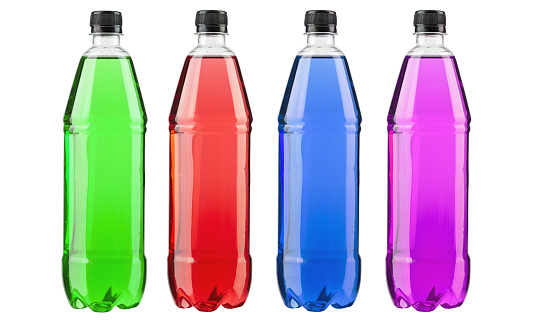 Energy drinks with different flavors isolated on white background. Plastics bottles with colorful liquid. File contains clipping path.