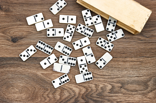 a group of white domino tiles on a wood table