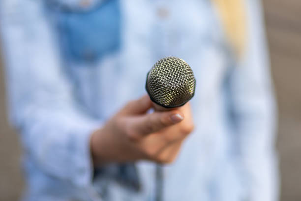istock Reporter on the spot, holding microphone in hand 2148601702