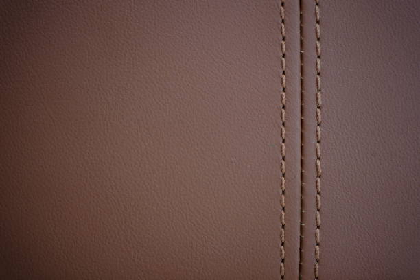 istock Brown thread on a brown natural leather car seat 2148602302