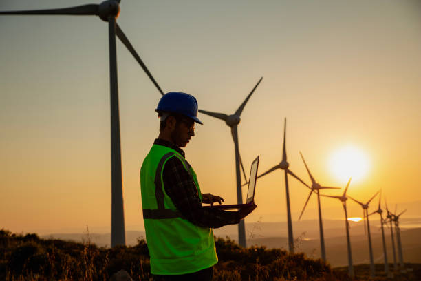 istock Renewable Energy Systems Innovator: Engineer Planning at Wind Turbines Farm 2148602969