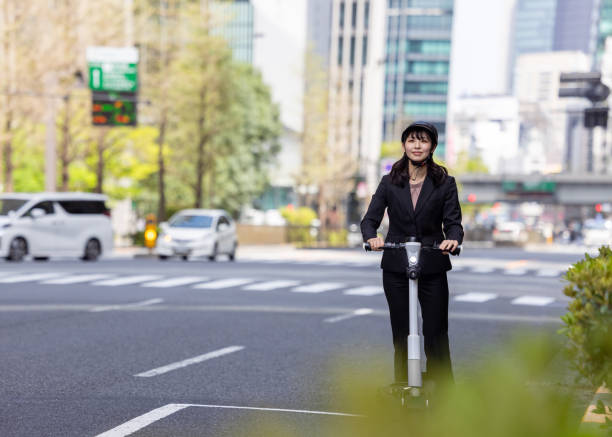 istock Young businesswoman commuting by e-scooter in city 2148603266