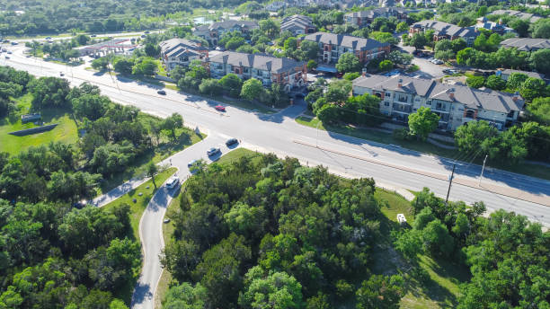 Aerial view large nature park busy car in out near new development suburban apartment complex along Brushy Creek Road, Cedar Park, Austin, Texas, lush green trees around Whippoorwill neighborhood. USA vista aérea de un gran parque natural ocupado en coche cerca de un nuevo complejo de apartamentos suburbanos de desarrollo a lo largo de brushy creek road, cedar park, austin, texas, exuberantes árboles verdes alrededor del vecindario de whippoorwill