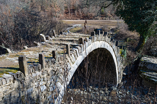 View of the traditional stone Kapetan Arkouda bridge near the village of Kipi in Zagori of Epirus, Greece