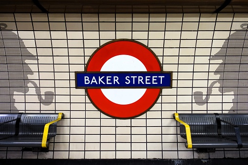 London, England, UK - April 13th 2024: Baker Street London Underground station roundel and silhouette motifs of Sherlock Holmes on platform