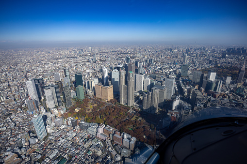 View from helicopter flying over Shinjuku high raised buildings