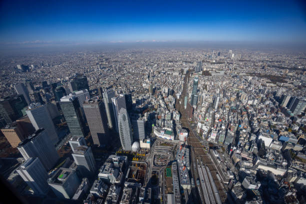 View from helicopter flying over Shinjuku high raised buildings