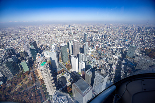 View from helicopter flying over Shinjuku high raised buildings