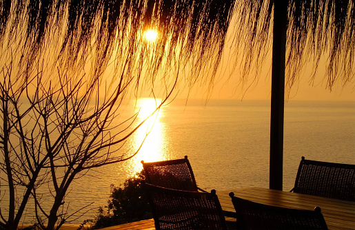 A golden dramatic island sunset from a dinner deck