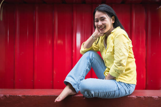 portrait asian woman  next to wall