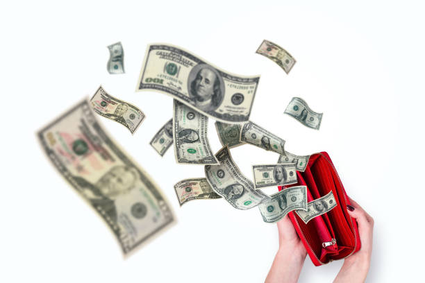istock Female hands holding a red wallet and dollars flying, creative idea. Inflation and crisis, concept. Waste of money. Purchases. Money is flying away 2148606496