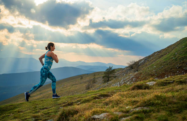 istock Woman athlete trail runner, running and climbing mountain cliff 2148607206
