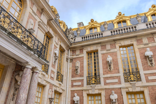 Chateau de Versailles, Versailles, France - December 28, 2023:  The Chateau de Versailles viewed from Royal Courtyard (Cour Royale) in a cloudy morning.  HDR encoded.