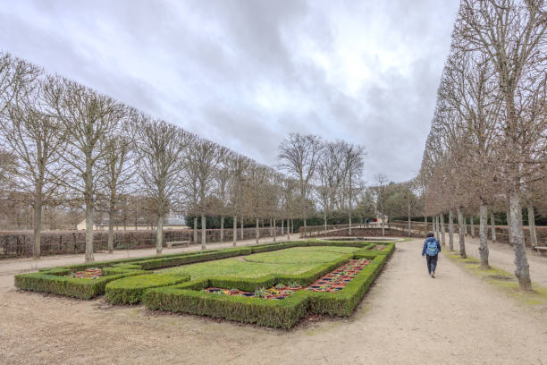 Chateau de Versailles, Versailles, France - December 28, 2023:  Tourists in the French Garden of the Chateau de Versailles on a cloudy day.  HDR encode