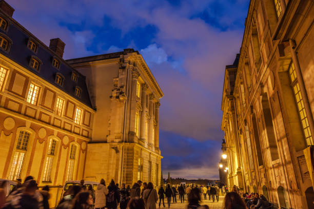 Chateau de Versailles, Versailles, France - December 28, 2023:  Tourists exiting the Chateau de Versailles during the blue hour.  HDR encoded.