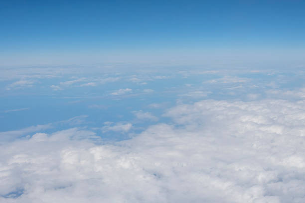 istock An aerial view of white fluffy clouds and sky. 2148607969